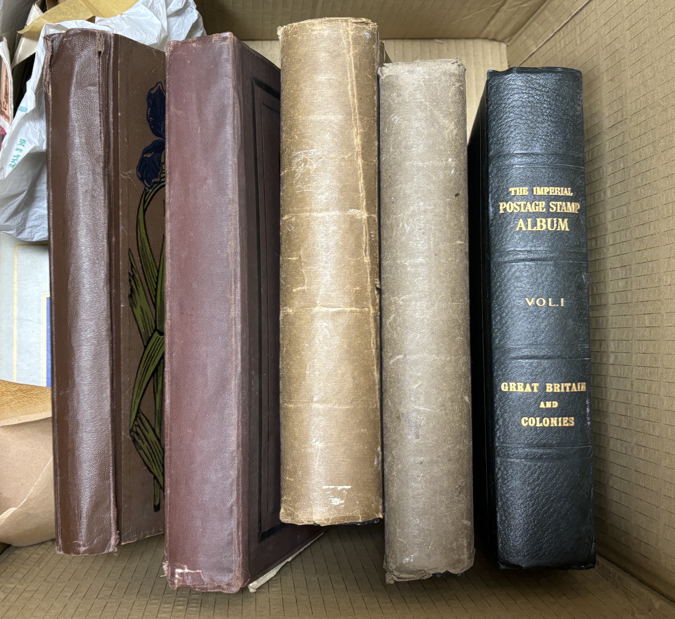 The Imperial Postage Stamp Album in three volumes, containing a stamp collection which includes some early stamps from Great Britain and the Empire, a Penny Black, early penny reds, and twopenny blues, etc. together with